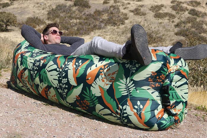 Man reclning on inflatable air sofa