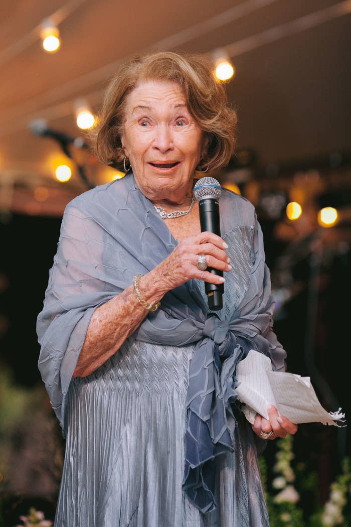 My grandmother with a microphone in hand, giving a speech at my wedding.