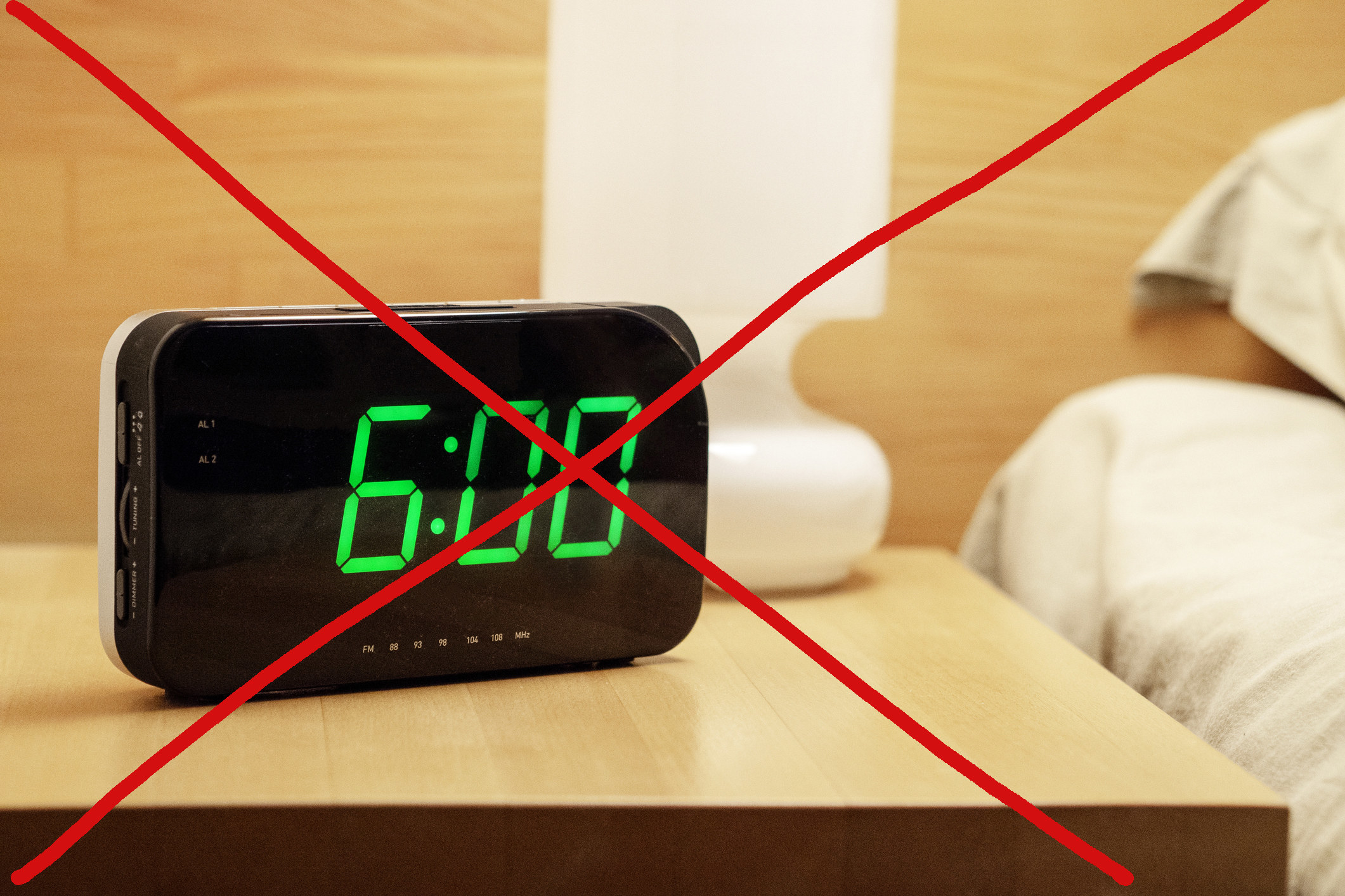 An alarm clock set to 6:00 a.m. but the entire image is crossed out