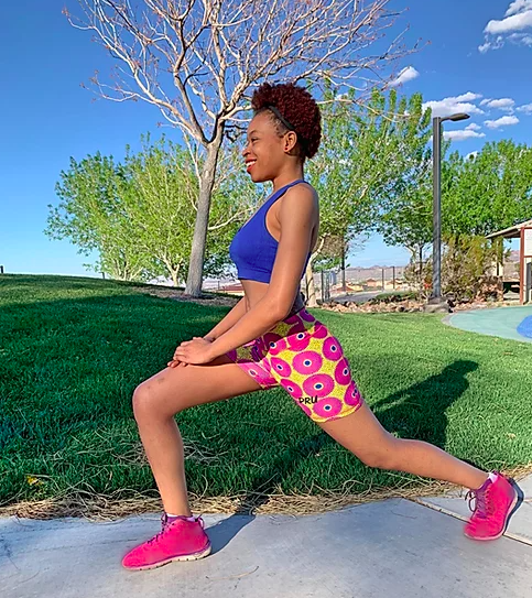 Model wears blue and yellow-patterned bike shorts with pink sneakers