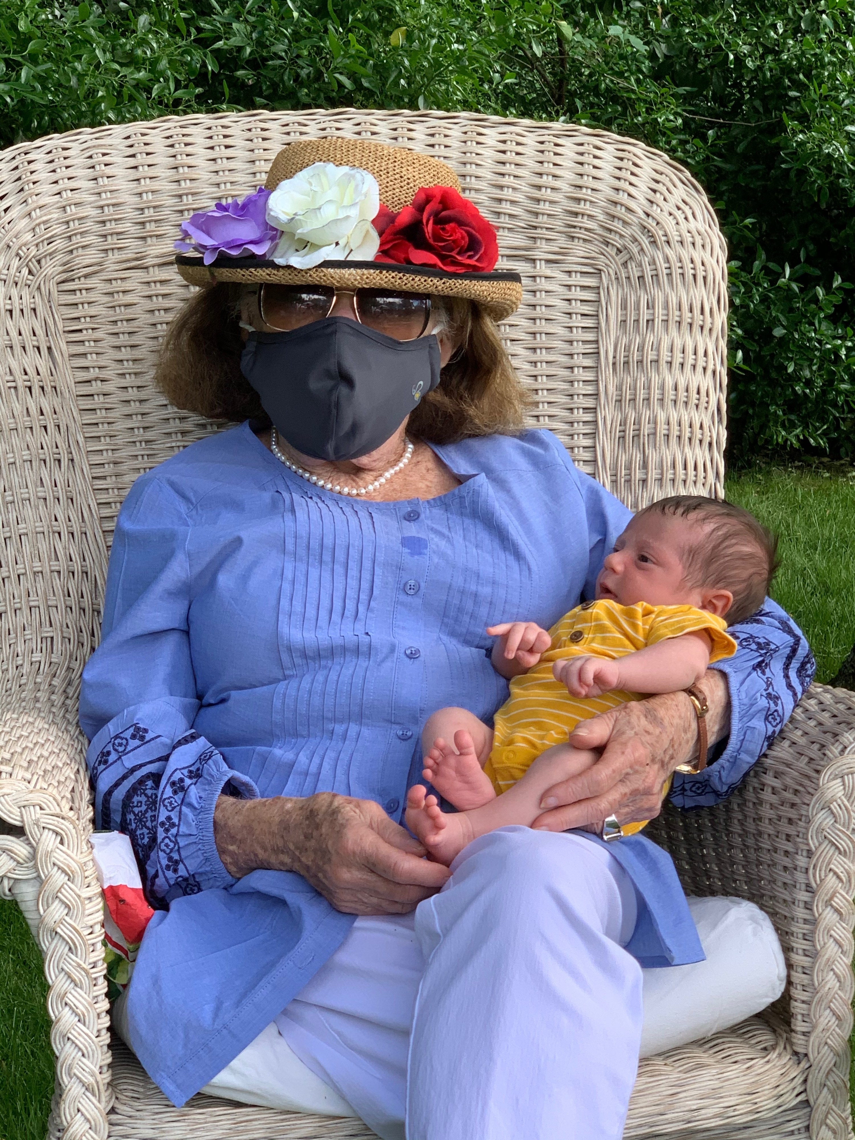 My grandmother holding her great grandson for the first time, wearing a mask!