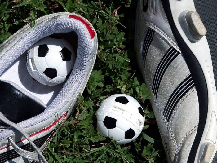 A pair of soccer Sneaker Balls inside soccer cleats