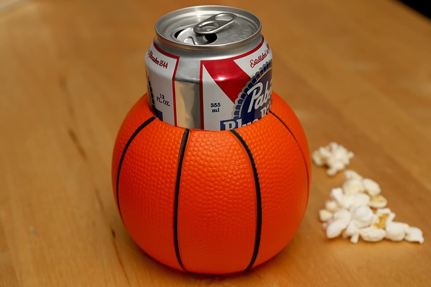 A basketball beverage holder with a drink inside