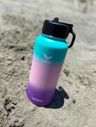 reviewer pic of rainbow gradient water bottle on a rock 