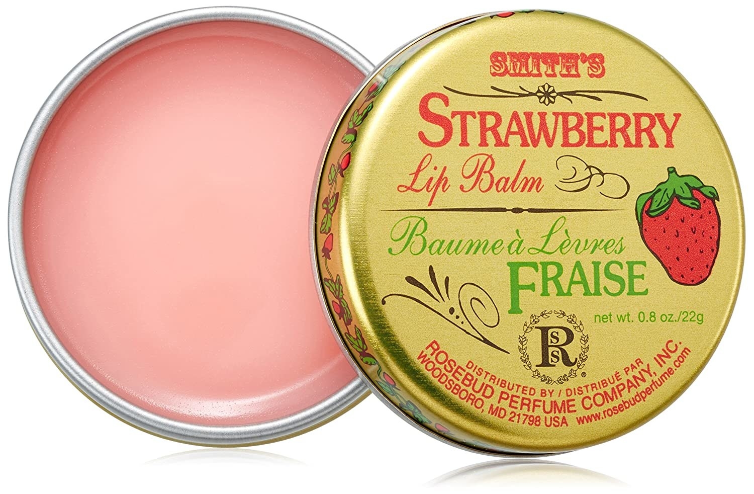 a strawberry pink lip balm in a gold tin