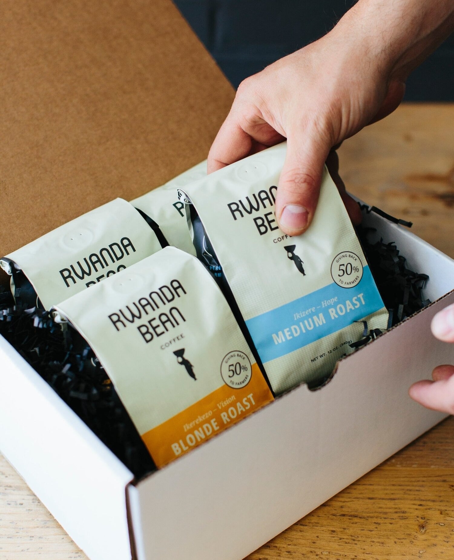 box full of four different bags of Rwanda bean coffee