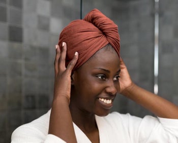 Model with the t-shirt towel in burnt orange wrapped around their head