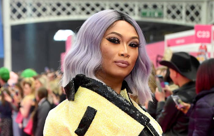 A photo of Jujubee in a yellow sequin Chanel–looking jacket at DragCon UK