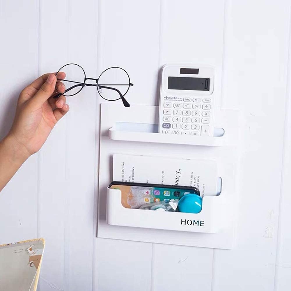 Adhesive pockets holding glasses, a calculator, a phone, and other trinkets
