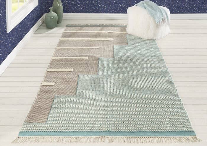 Memphis-inspired area rug in powder blue and grey with fringe 