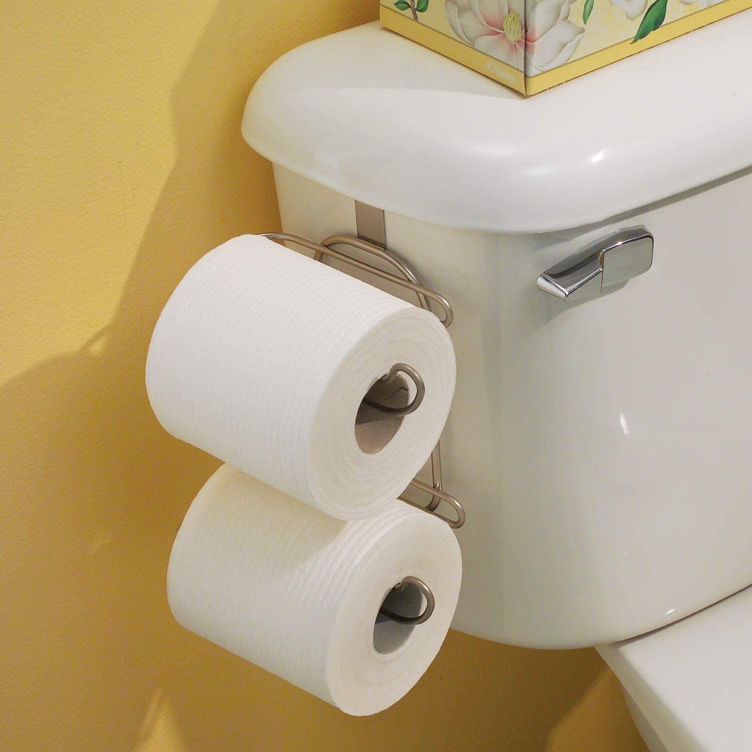 A double-decker toilet paper holder clipped to a toilet