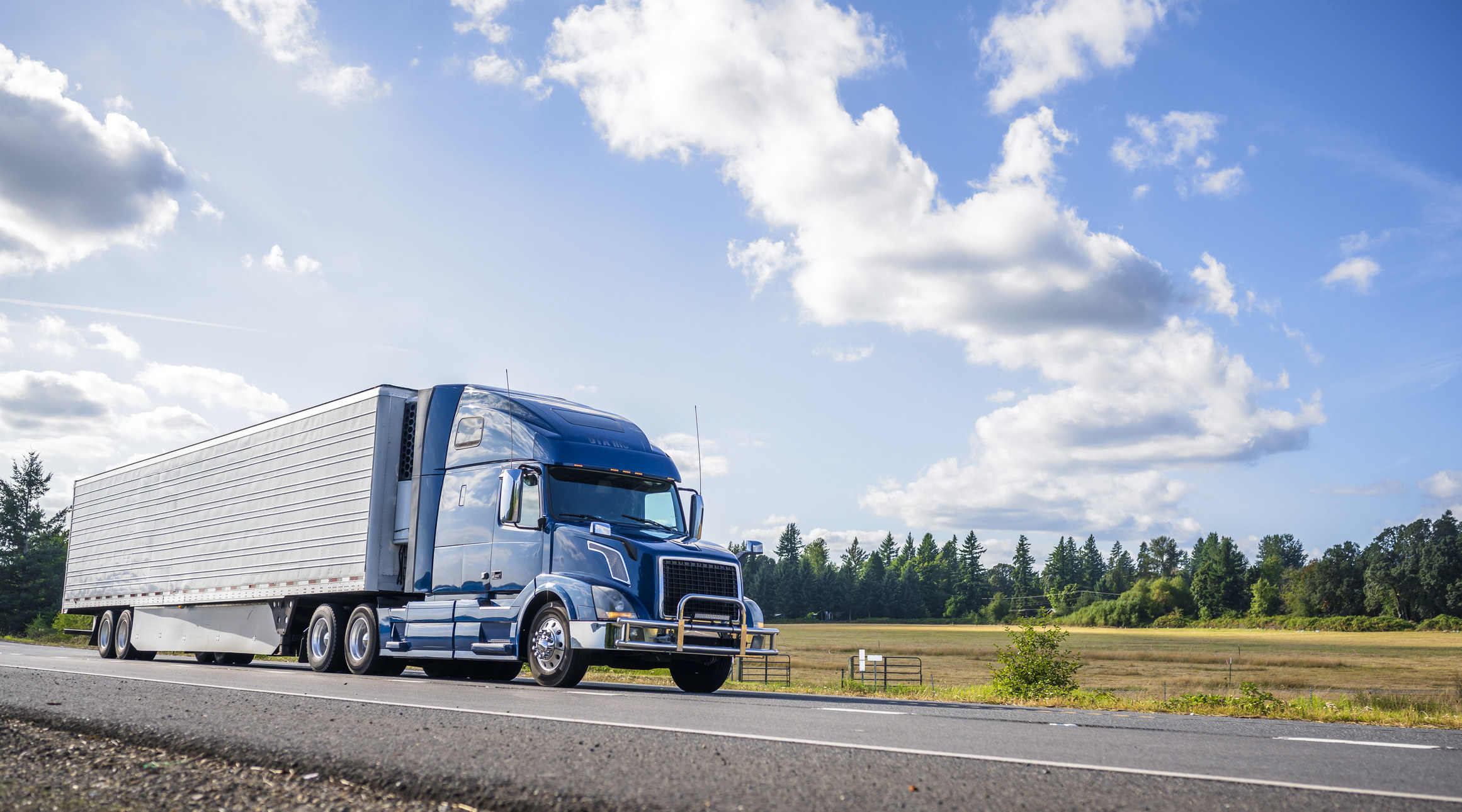 Photo of a truck speeding down a highway