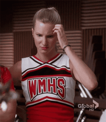 Heather Morris as Brittany scratching her head.