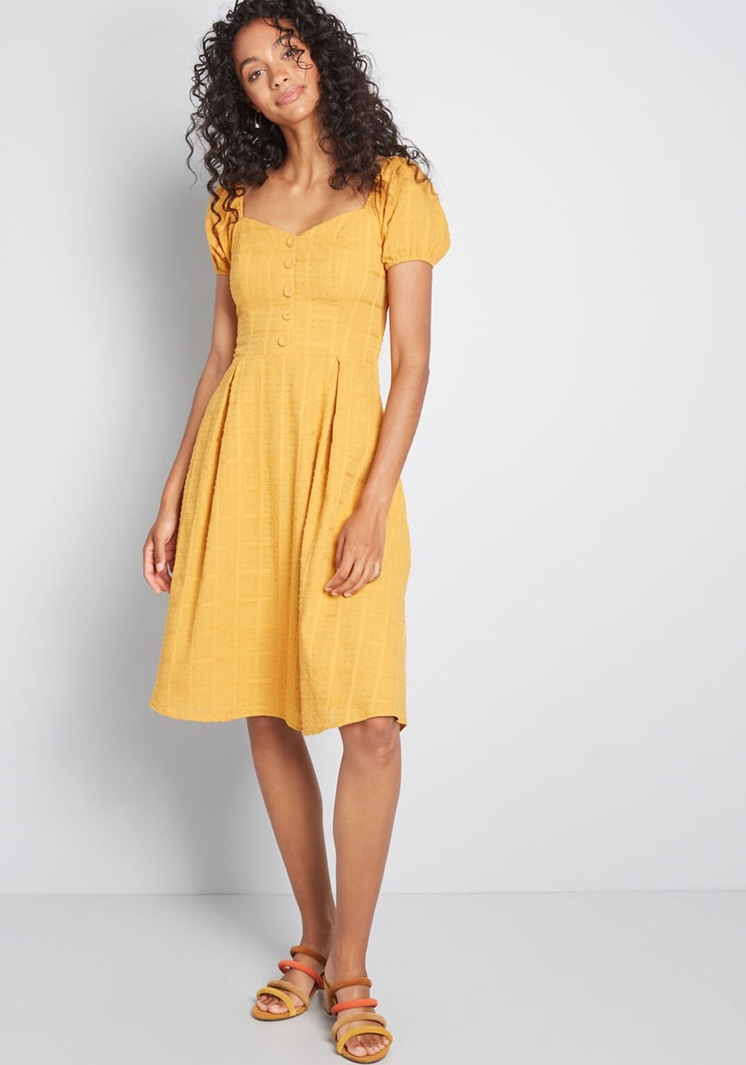 model wearing midi marigold dress
