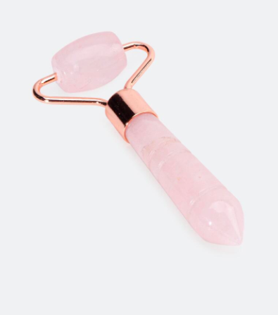 A pink and gold beauty roller with rose quartz