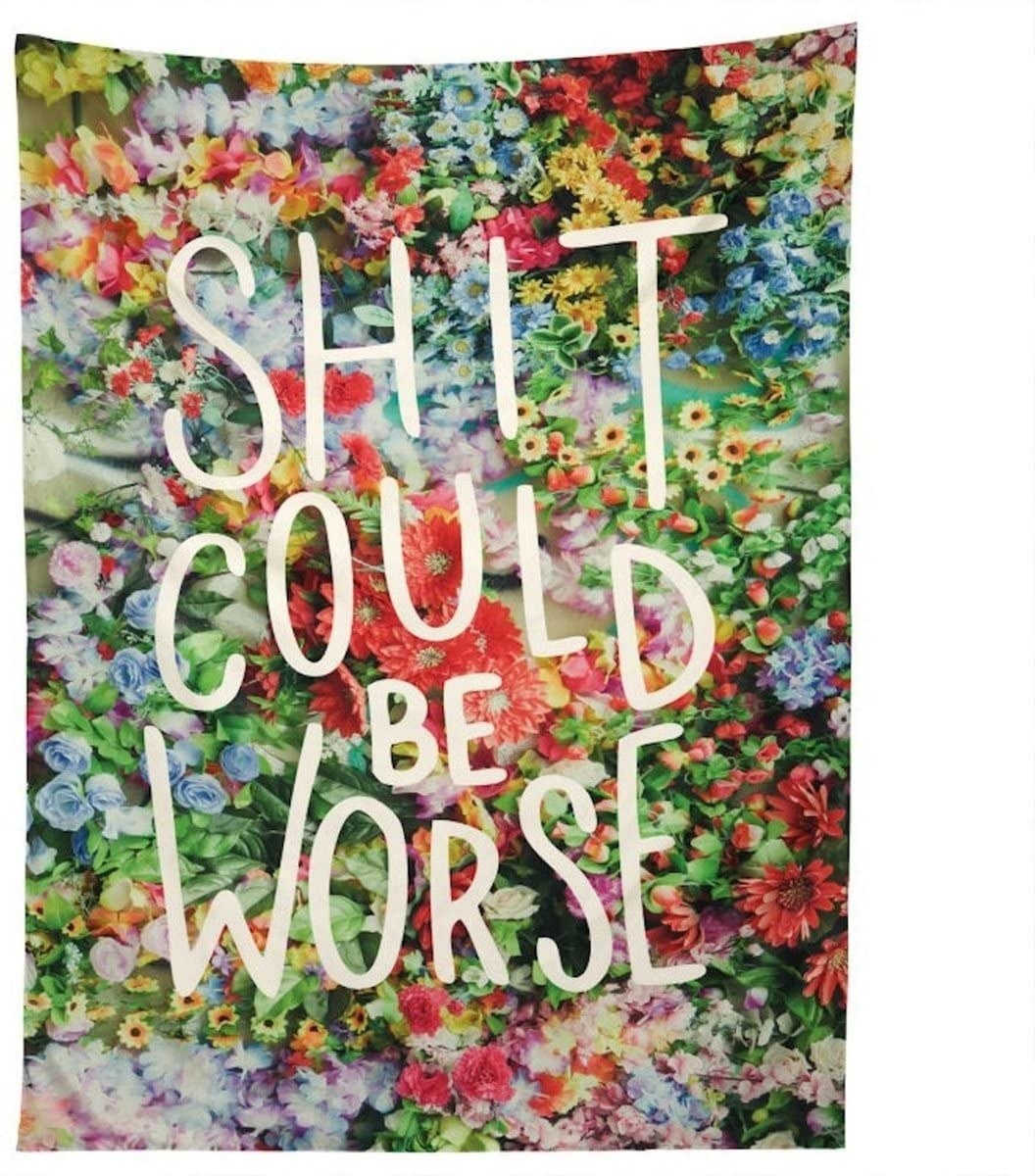 A floral blanket that says shit could be worse