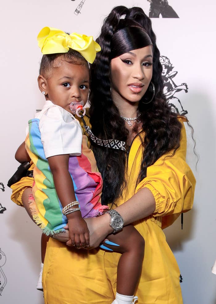 Cardi B poses with her daughter while wearing matching vibrant outfits
