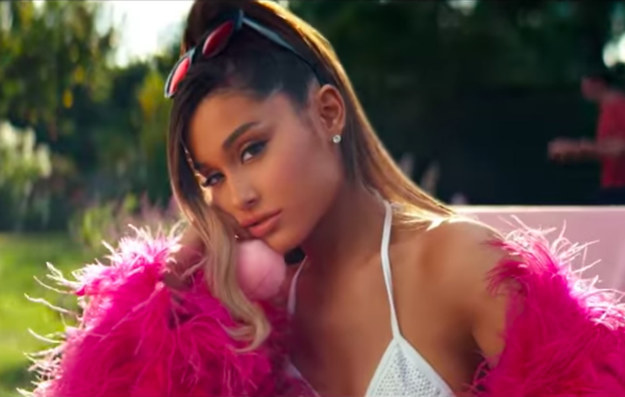 Ariana Grande with her head on her hand during a music video