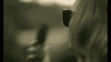 GIF of Adele slamming her flip phone shut from the music video for Hello
