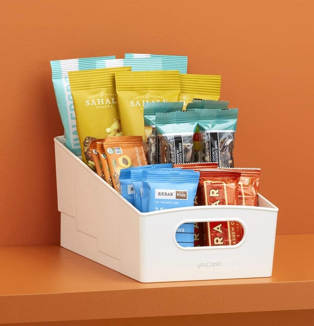 A variety of snacks in the four-tier bin