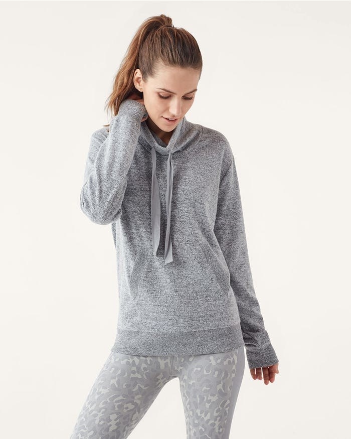 Model wearing the sweatshirt with funnel neck and front pocket in grey