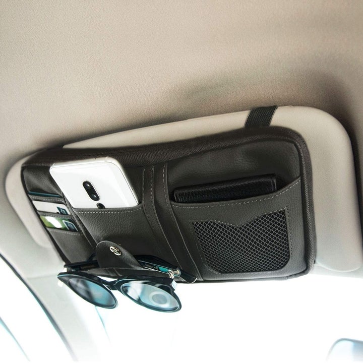 A closed visor organizer holding a phone and glasses