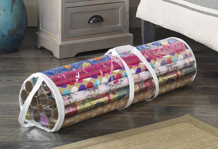 A gift wrap tote filled with rolls of wrapping paper
