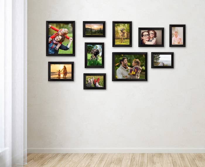 Multiple frames hung on a wall to make a gallery wall. 