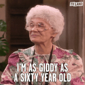 A GIF of a person smiling saying I&#x27;m as giddy as a 60 year old
