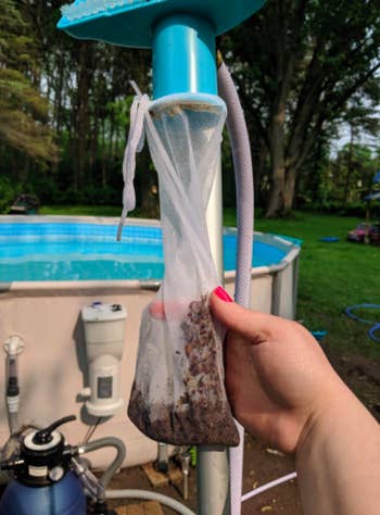 Customer uses a blue pool vacuum head to remove debris from their pool
