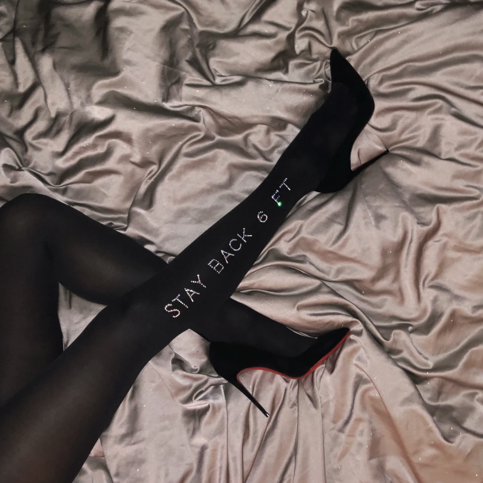 Black opaque tights with the words &quot;stay back 6 ft&quot; bedazzled on the right leg 
