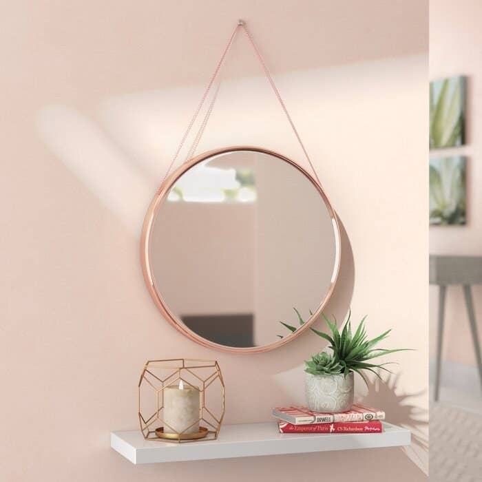Rhein accent mirror in rose gold finish with a hanging chain 