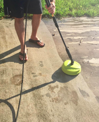 Same reviewer shows clean driveway side and grimy driveway side while using the same electric pressure washer