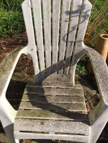 Reviewer's mold-covered white patio chair before using the stain remover spray