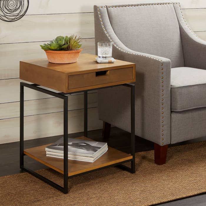 Two tier wooden end table with black metal legs 