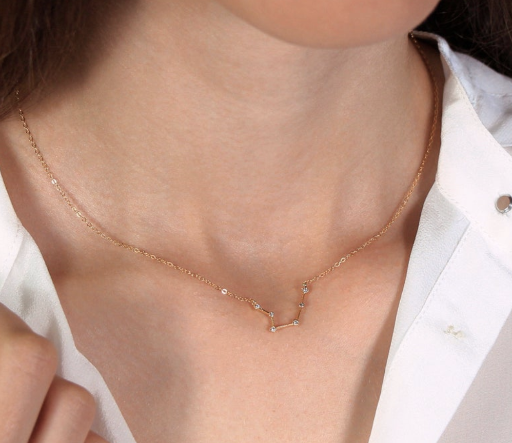 A necklace with a zodiac constellation-shaped shaped charm 