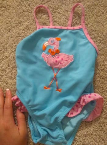 Same pink and blue baby swimsuit without stains after using the same stain remover