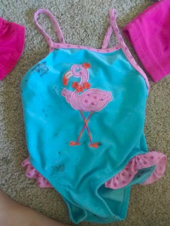 Same pink and blue baby swimsuit without stains after using the same stain remover