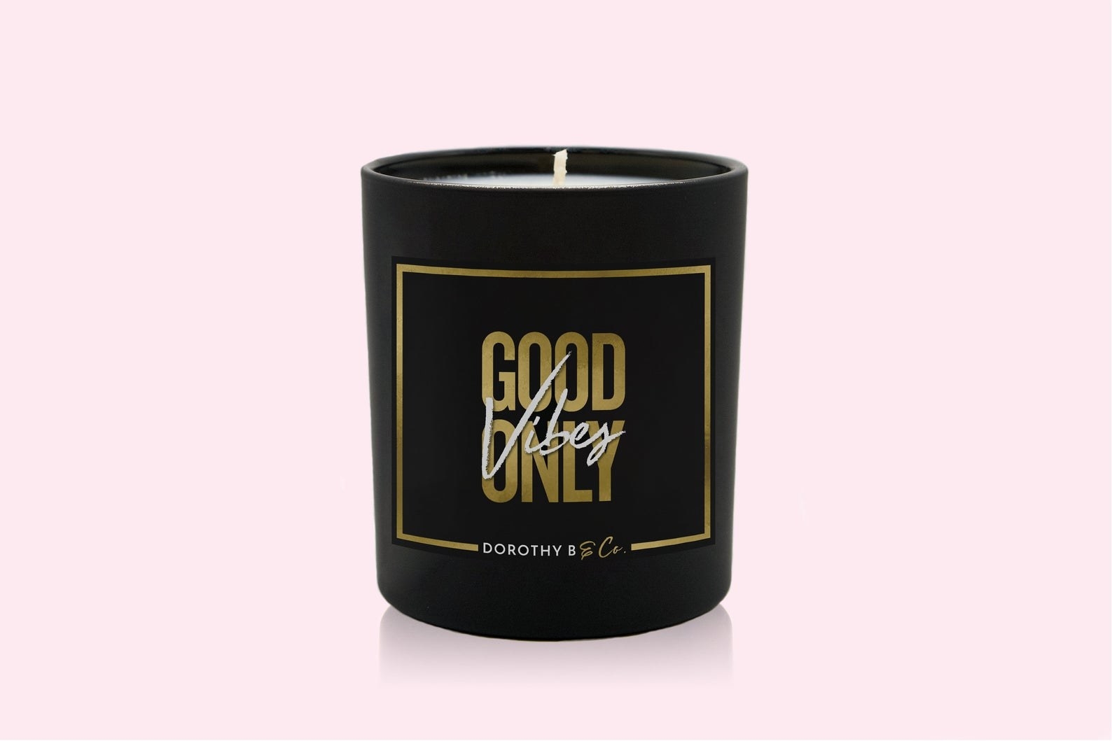 A black candle that says &quot;Good Vibes Only&quot; in gold 