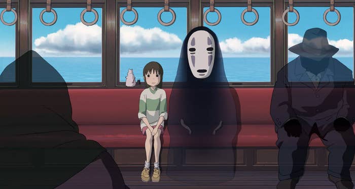 Chihiro and No Face sitting on the train in &quot;Spirited Away&quot;