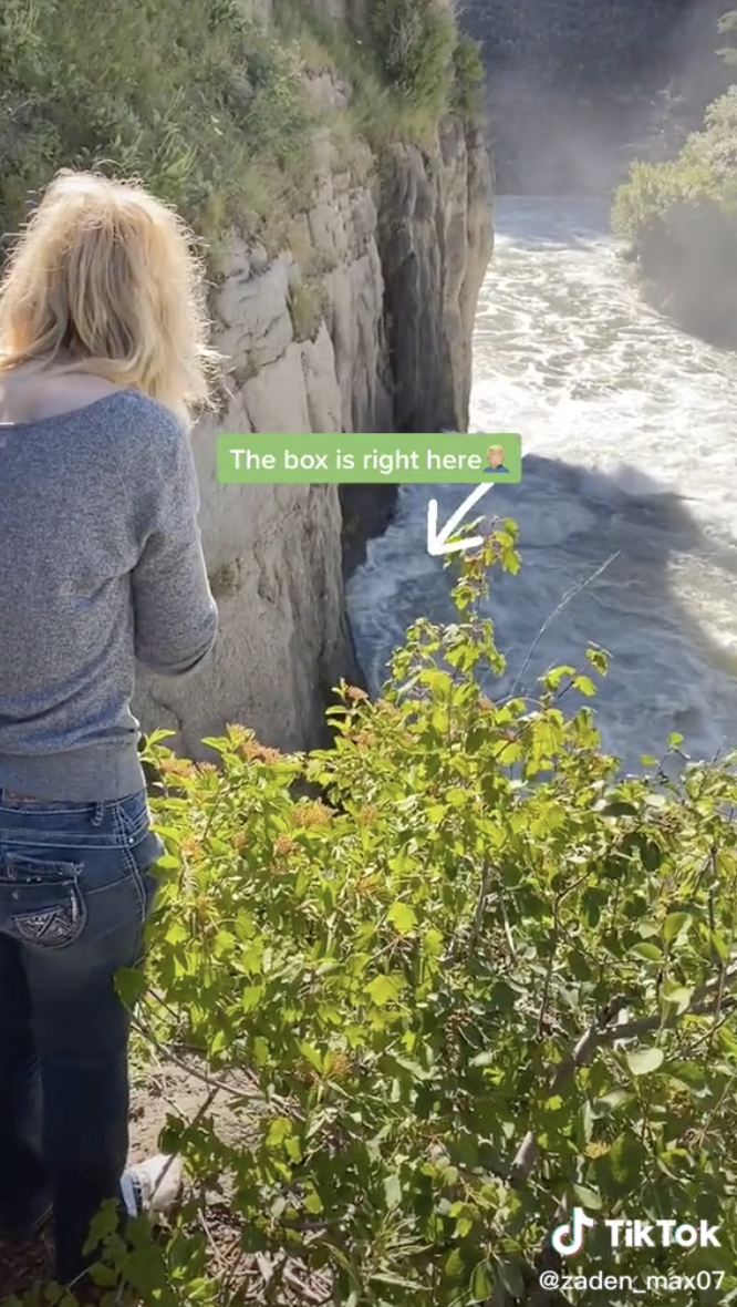 Photo of Courtney looking over waterfall edge.