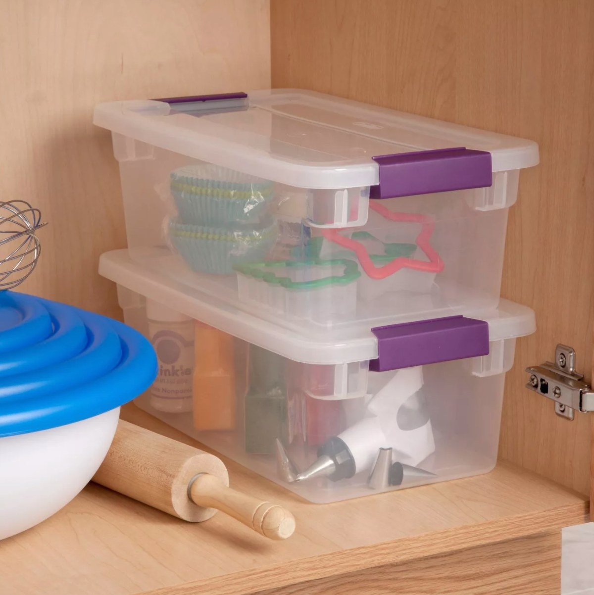 Two plastic see-through boxes with purple handles on the lids