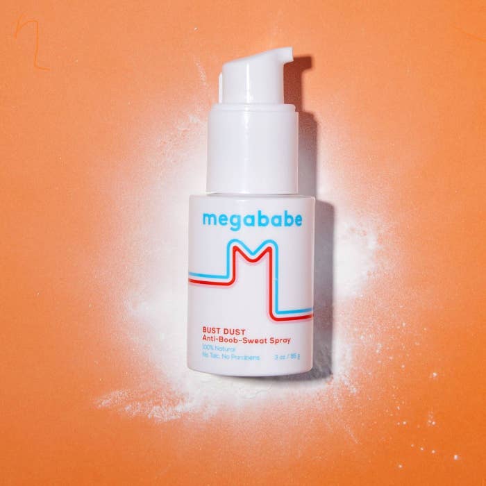 A white spray bottle with a Megababe  logo in blue and red
