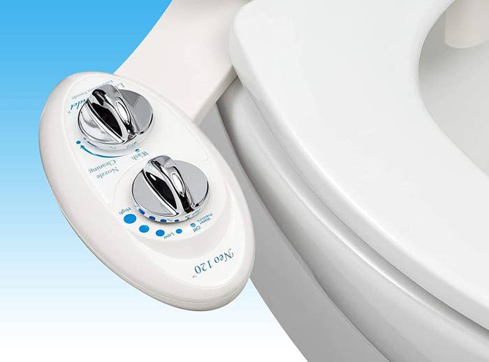 closeup of the white bidet seat attachment with dials