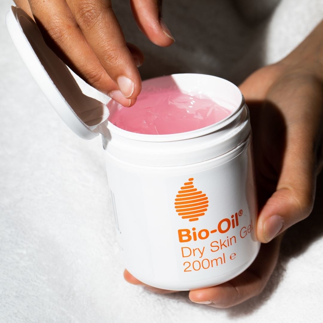 A person putting their hand into a tub of dry skin gel