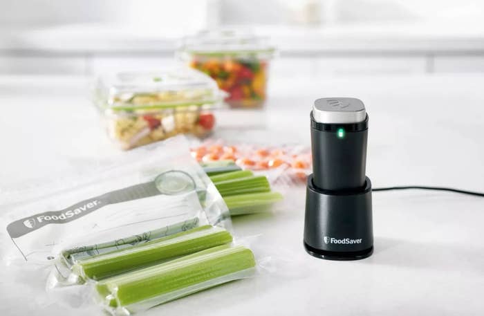 The small vacuum sealer next to a bag of celery