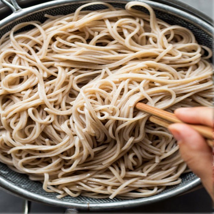 A bowl of plain cooked soba noodles.