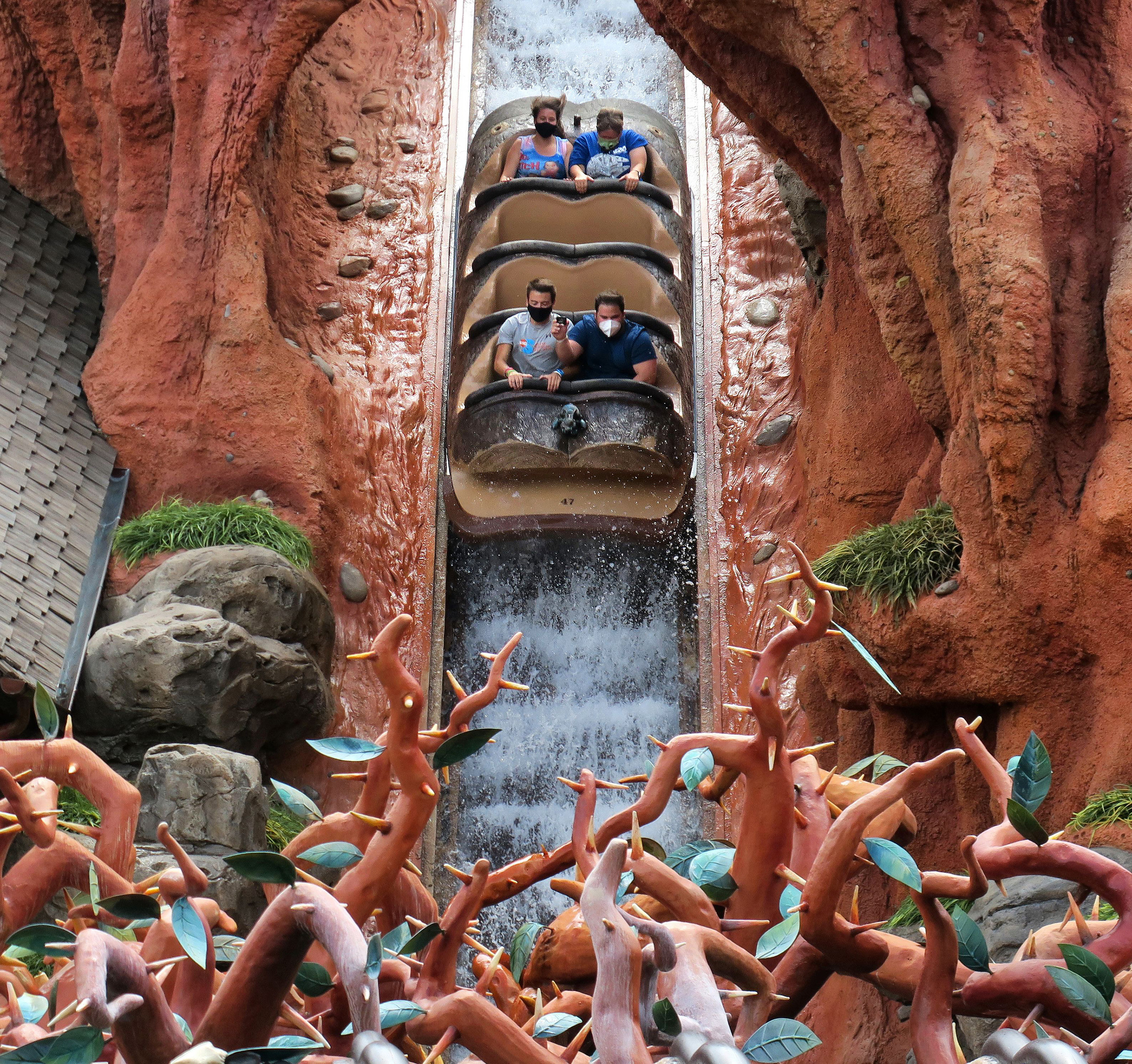 Four visitors ride Splash Mountain while separated by rows of seats