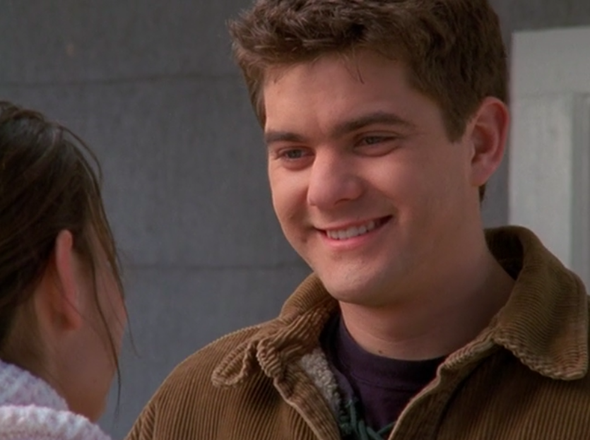 Pacey smiles at Joey before he teaches her how to drive. 