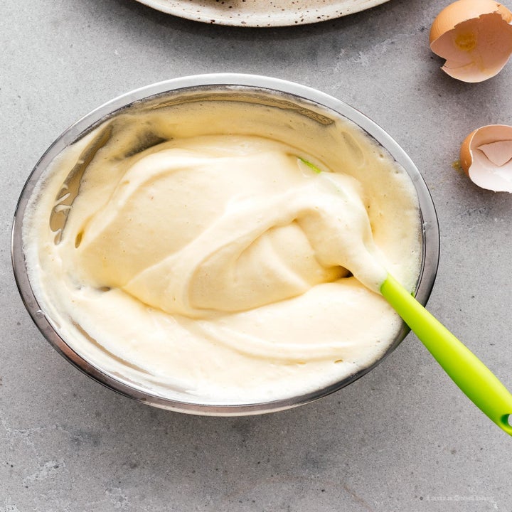 Egg batter for Japanese soufflé pancakes in a mixing bowl.